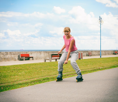 Young female exercise outdoor on rollerblades.