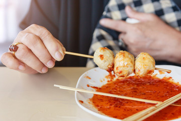 Roasted pork balls or meatballs with sweet spicy sauce, Closed up