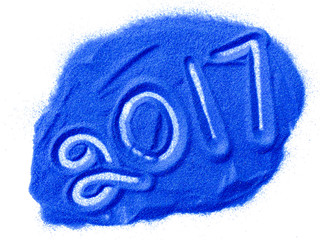 2017 New Year on blue sand isolated on white background.