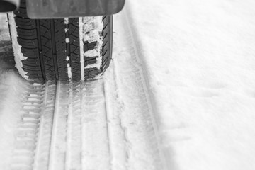 Car tire on snowy winter road