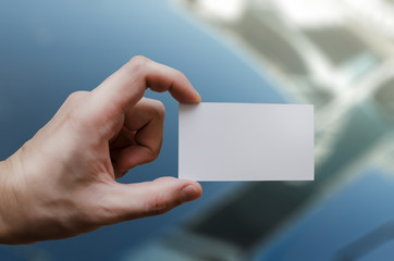 Hand holding a  white business card mockup