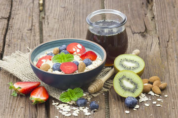 healthy breakfast - muesli with fruit, yogurt and honey