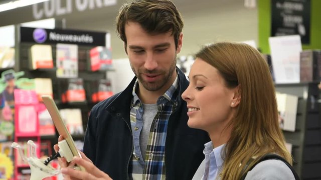 Couple in store choosing digital tablet