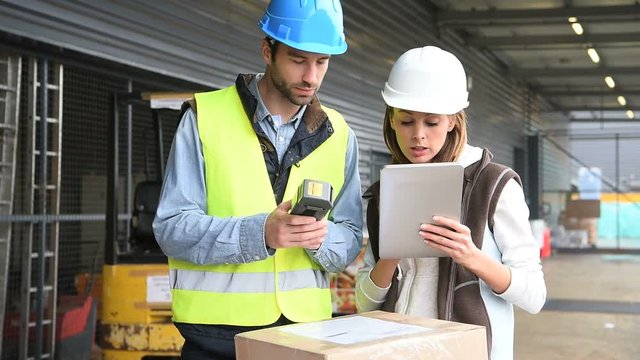 Store manager with warehouseman checking goods reception