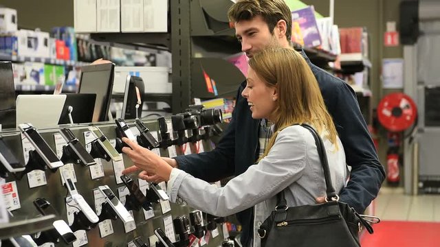 Couple in department store choosing smartphone
