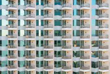 Pattern of balconies and windows of apartment building.