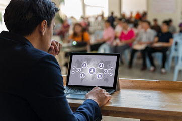 Businessman sitting and using computer laptop showing the Social