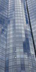 wall glass skyscraper with reflection of the sky at night.