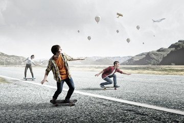 Fototapeta premium Teenagers ride skateboards . Mixed media