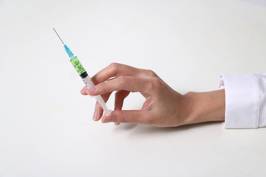 injector held by woman hand