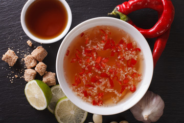 Vietnamese traditional Nuoc Cham sauce closeup and ingredients. horizontal top view