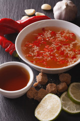 Vietnamese traditional Nuoc Cham sauce close up in a bowl. vertical