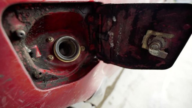 Filling Up Gas Putting Nozzle Into Old Dirty Muddy Red Truck With Key Lock