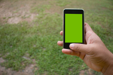 Soft focus of hand using mobile smart phone with blurred backgro