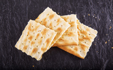 Crackers over black stone background