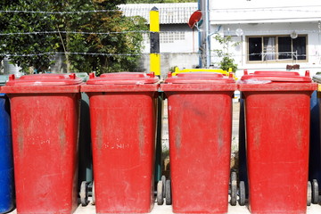 Large red wheelie bins for waste contamination in the tenement house.