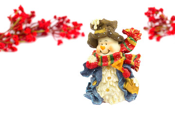 Cute snowman figurine with red berries on white background