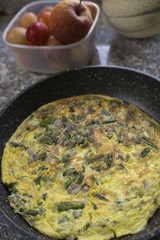 omelette with asparagus in pan. flat lay