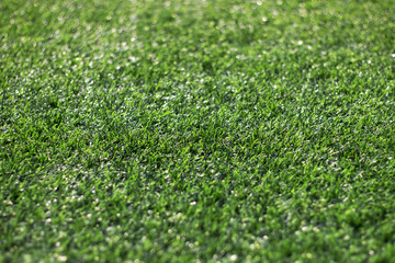 Naklejka premium Artificial grass and the sun light as a background