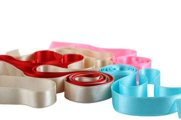 Multicolored ribbons, blue, red, pink and beige on a white background isolated