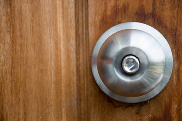 Doorknob silver stick blacked beautiful brown wooden door.