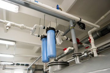 Blue water filters. Pipes with small valves. Effective technologies of water purification. New...
