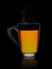 Hot flavored tea in a glass on a black background