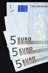 Five euro on black background
