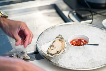 arranging oyster on the plate in restaurant