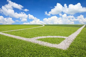 Obraz premium Artificial turf soccer field and blue sky