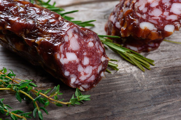 Salami. Dry sausage on a wooden table