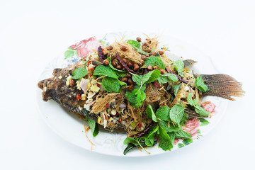 Fried Tilapia with Mixed Herb on White Background.Thai food.