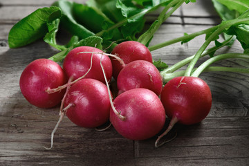 radishes on a wooden table © spaxiax