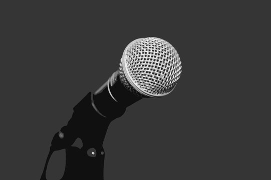Dynamic microphone background. Accessory indispensable singers. Symbol of musical performers. Scenario attribute to performances of artists. Tool for voice karaoke. 