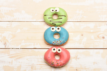 Funny glazed donuts on vintage background