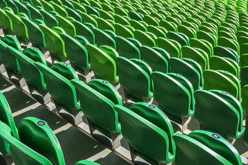 Obraz premium Seating rows in a stadium with weathered chairs