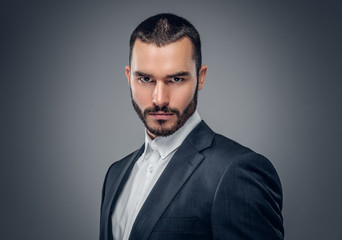 A man in a suit isolated on grey background.