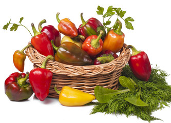 on white background vegetables peppers in basket and greens
