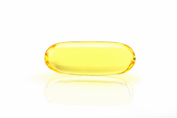 Close up golden color fish oil supplement in soft gel capsule