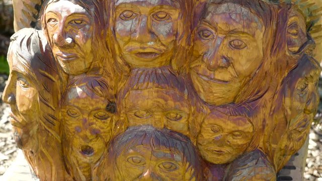 Wooden carvings of many faces of men and women the good carvings of the faces are made by expert in carving