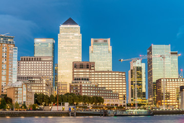 Sunset skyline of Canary Wharf, London reflections