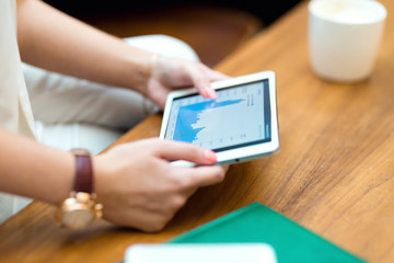 Young beautiful girl in white suit sitting in cafe