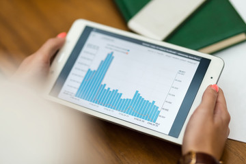 Young beautiful girl in white suit sitting in cafe