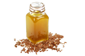 Linseed oil and flax seeds in glass bottle isolated on white
