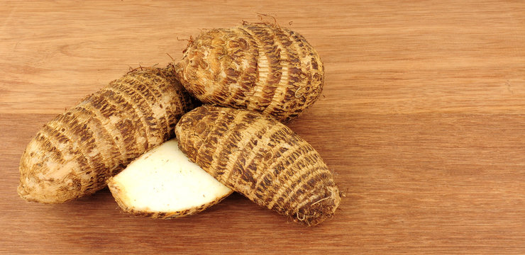 Raw Eddoe Vegetables On A Wooden Background