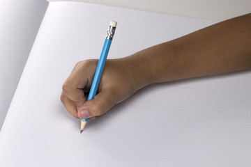 hand of a child drawing on white paper