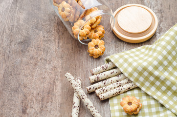 Chocolate wafer sticks and cookies on wooden table. Snack for br