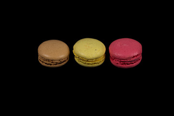 Stacks of multicolored macaroon isolated on black background