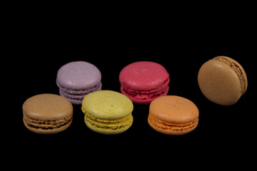 Stacks of multicolored macaroon isolated on black background
