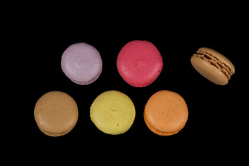 Stacks of multicolored macaroon isolated on black background